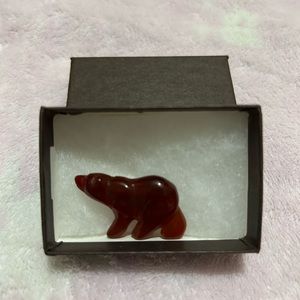 Carved stone bear brooch.